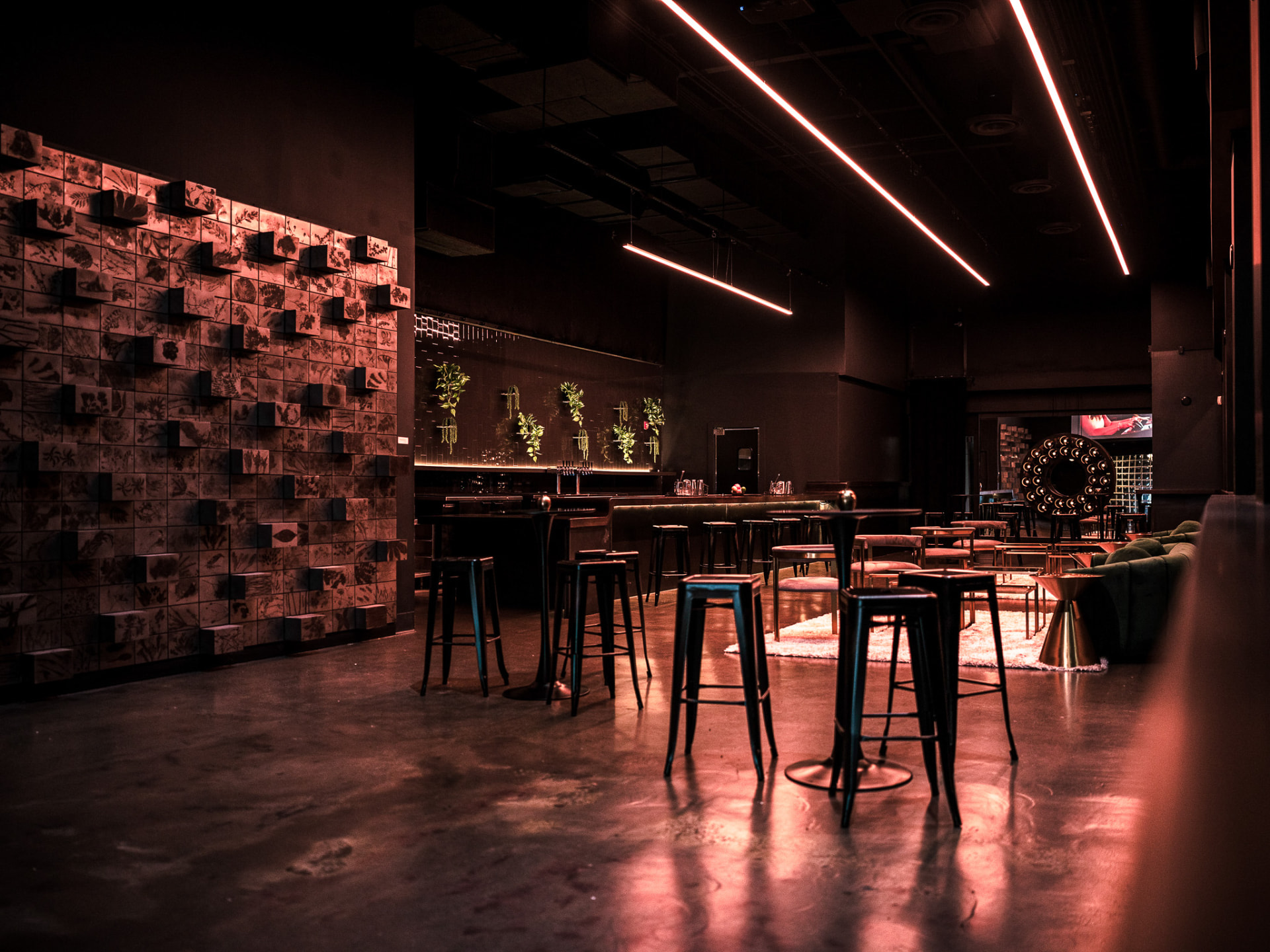 The Pearl lounge with warm linear lighting and cocktail seating